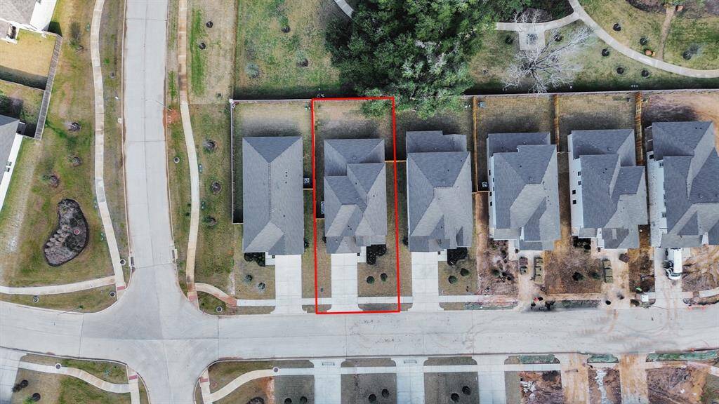 An aerial view of a spacious subdivision lot, highlighting a well-maintained yard and a fully fenced perimeter, offering both privacy andexpansive outdoor space.