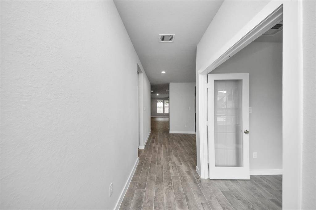 As you step into the threshold of this luxurious home, you'll soon be welcomed by anelegant glass door (to be installed). Inside, soaring ceilings amplify the spaciousness,while the refined wood-look tile flooring and oversized baseboards exudesophistication and charm.