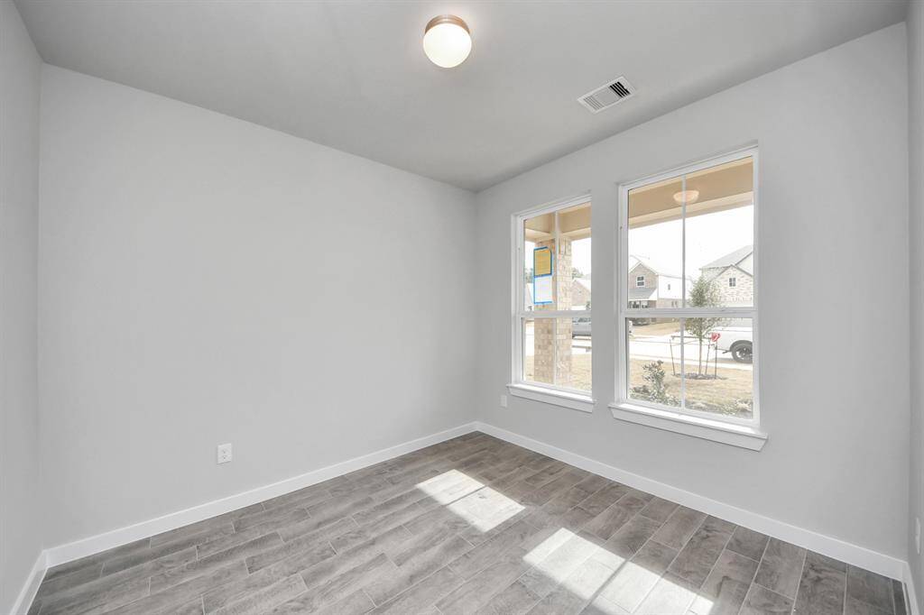 Step into the inviting home office, where elegant tile flooring adds a touch of freshnessand comfort to the workspace. Natural light pours through the window, creating aninspiring environment for productivity and focus.