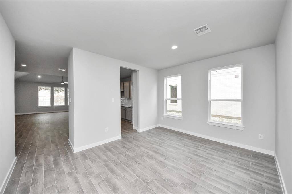 Make memories gathered around the table with your family and friends! This spacious diningroom features elegant flooring, custom paint, and adjacent to family room and kitchen foropen concept feel.