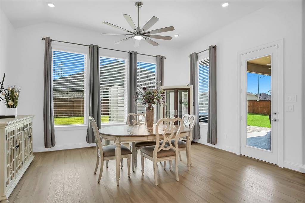 Tons of natural light flow into the dining and kitchen area through the large floor to ceiling windows.