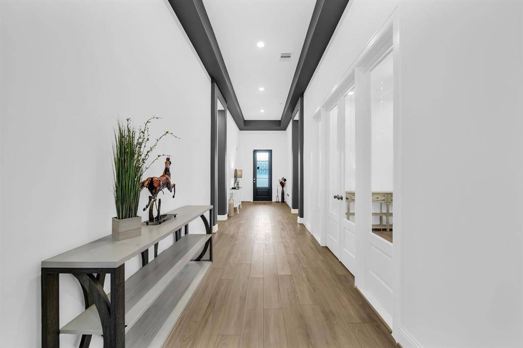 Heading back down the entry hall you will find the home office and 1/2 bath on your right and access to the secondary bedrooms, utility room and Next-Gen living space to your left.