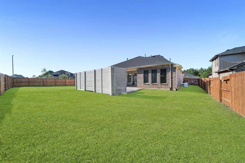 The backyard is enclosed with fencing sealed on both sides.