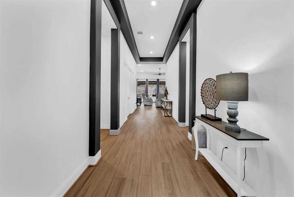 Step into a beautifully detailed entry with high ceilings that welcomes you into the heart of the home and connects to the versatile Next Gen space.