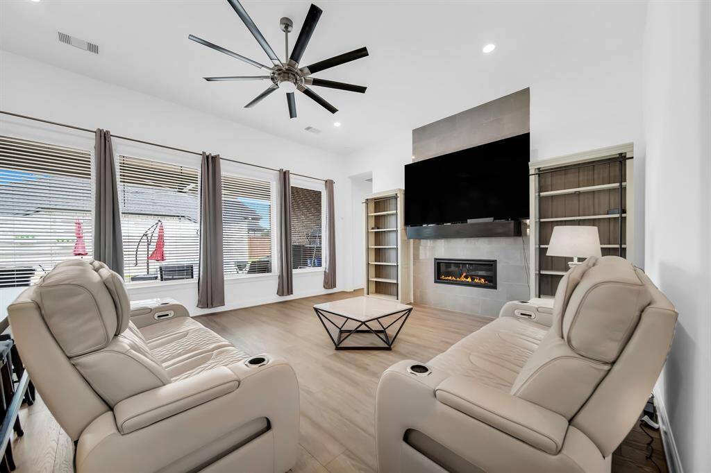 This large living area with natural lighting and 72" ceiling fan is the perfect place to relax.