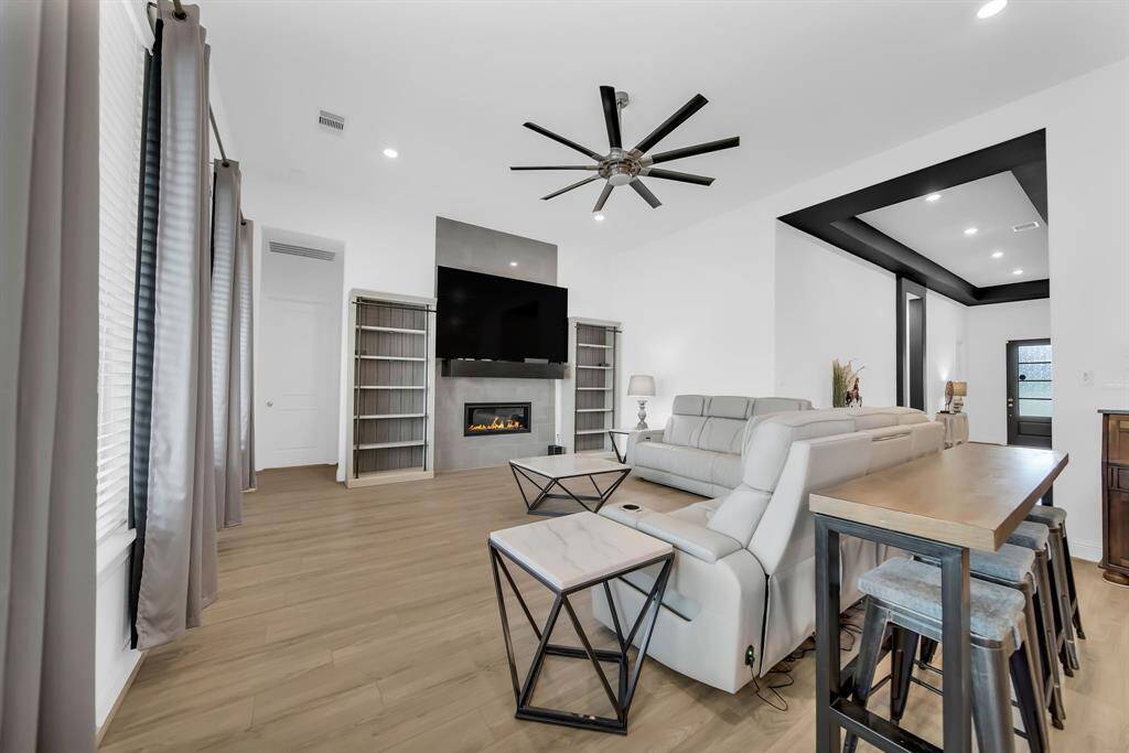 The gas fireplace is surrounded by beautiful marble tile.
