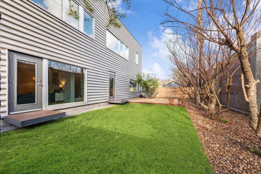 Green backyard with graveled space.