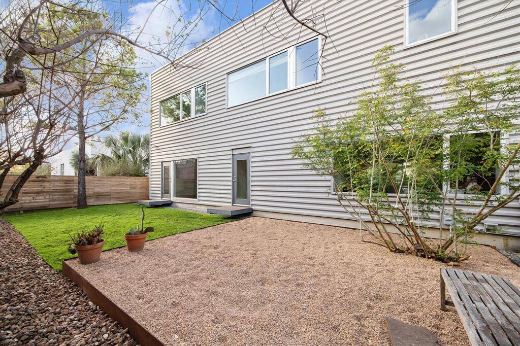 Green backyard with graveled space.