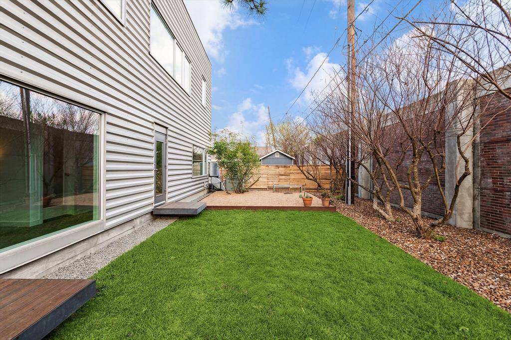 Green backyard with graveled space.