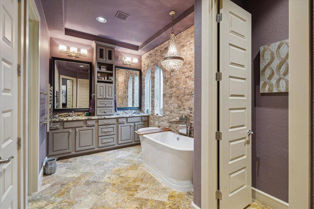 Absolutely glamourous primary bath with free-standing soaking tub & steam shower.