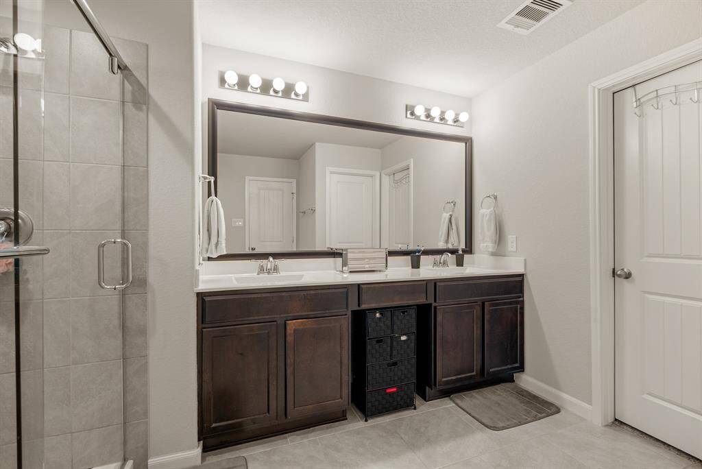 Experience hassle-free mornings with dual sinks and a spacious vanity area.