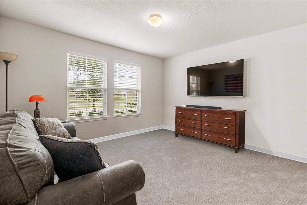 This is the largest of the secondary bedrooms, offering incredible versatility and space. Currently styled as a cozy game room, this room features plush carpeting, large windows that let in plenty of natural light, and a full-size closet—making it perfect as a guest suite, media room, or additional bedroom. Whether you’re looking for a flexible living area or a comfortable private retreat, this generously sized room delivers endless potential.