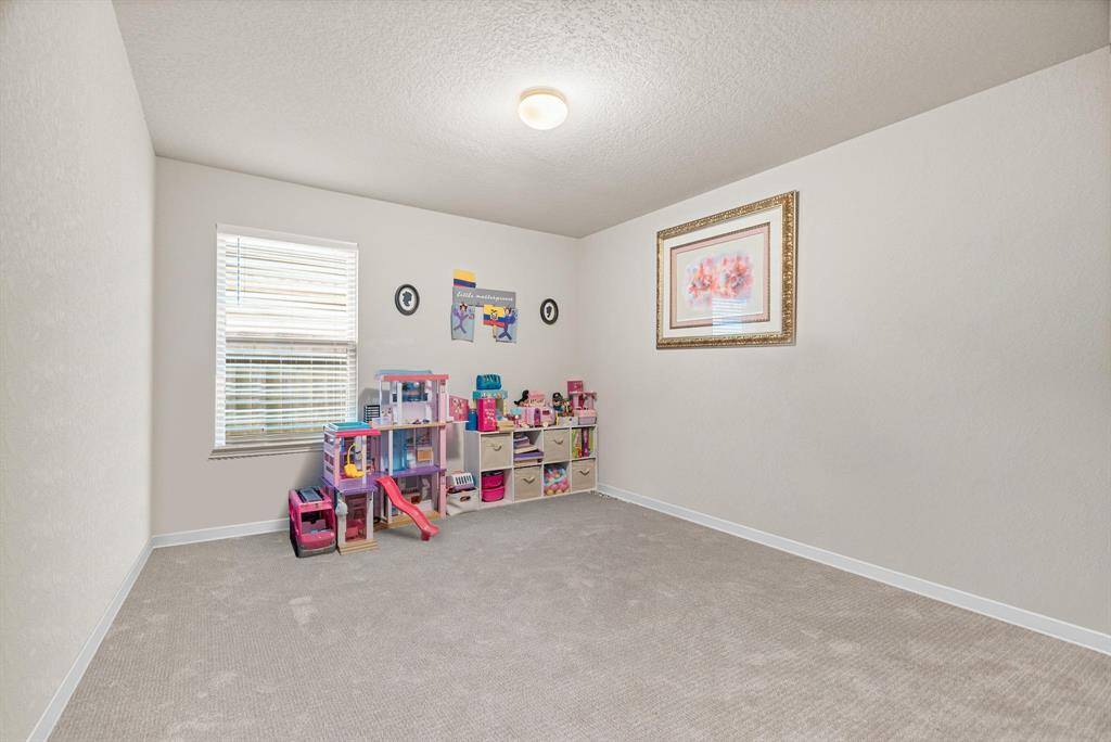 This charming secondary bedroom offers a spacious and versatile layout, perfect for a child’s room, guest space, or creative play area. Featuring soft, neutral carpeting and a large window that fills the room with natural light, this inviting space is both comfortable and functional. With a standard closet and plenty of room for furniture or storage, it’s ready to adapt to your family’s needs.