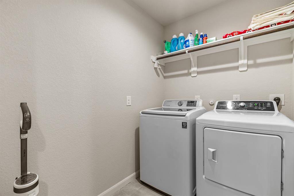 Spacious laundry room conveniently located near secondary bedrooms and bathroom, with ample storage for all your cleaning essentials.