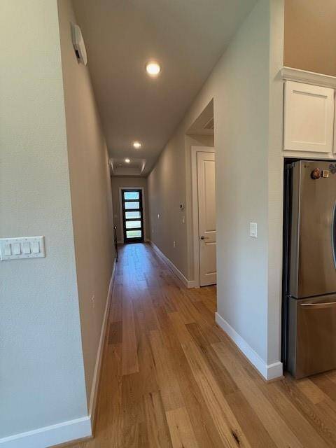 View of the front door from the main room. Guest Rooms down the hall to the left, garage and laudry room on the right. Master Bedroom seperated and at the back of the house behind.