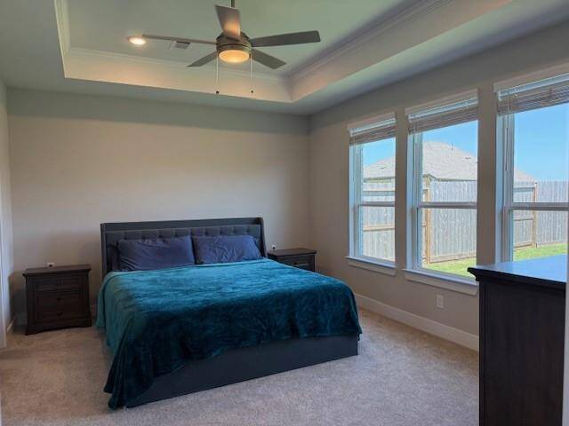 Spacious Master Bedroom with tray ceiling and recessed lighting.