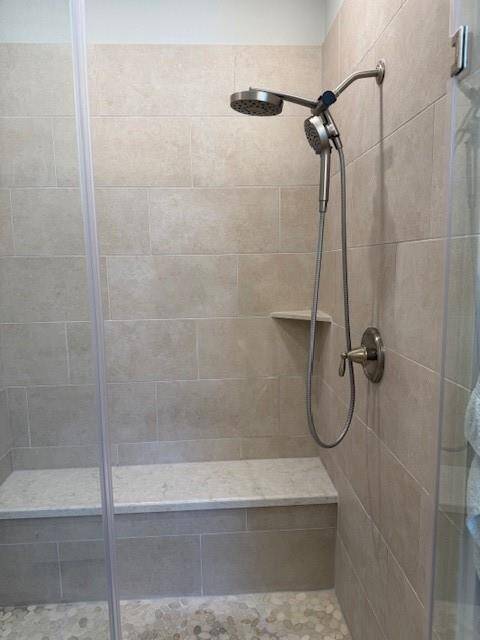 Well appointed glass enclosed zero entry shower.