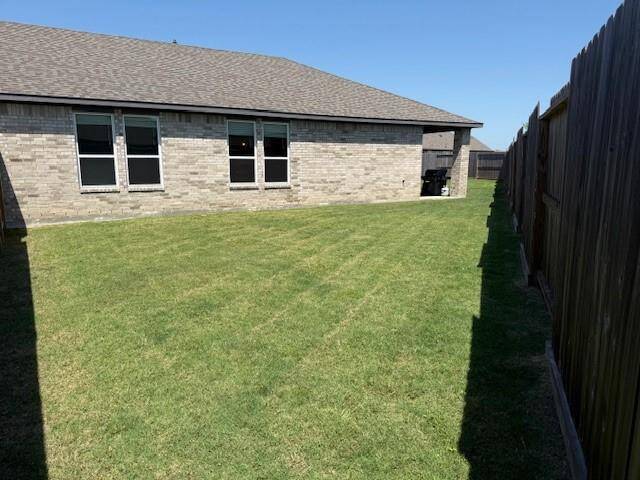 View from the front fence line. Angled lot gives plenty of green space.