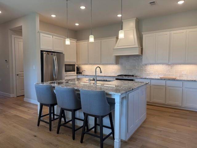 Counter Space Galore with Gorgeous Countertops. Also great task lighting features.