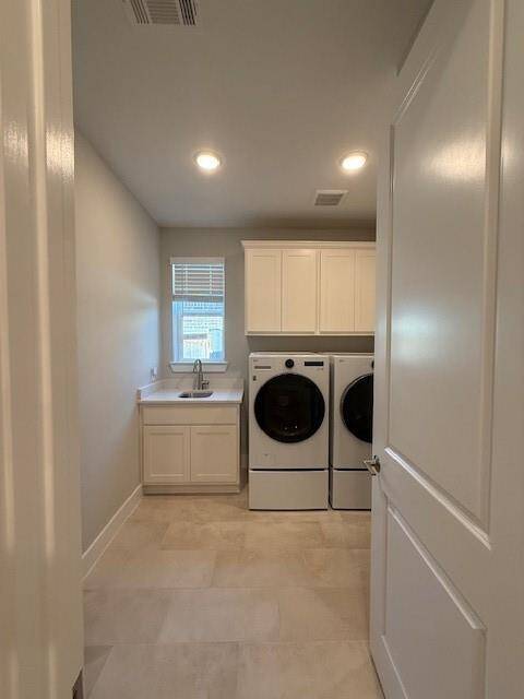 Spacious and Enclosed Laundry Room has plenty of cabinet space, a window and sink.