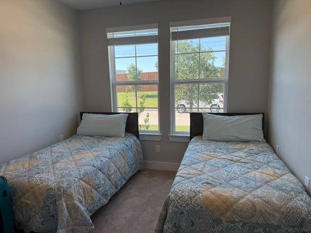 Front Guest Bedroom has ample room with a double door closet and is bright with tall windows.