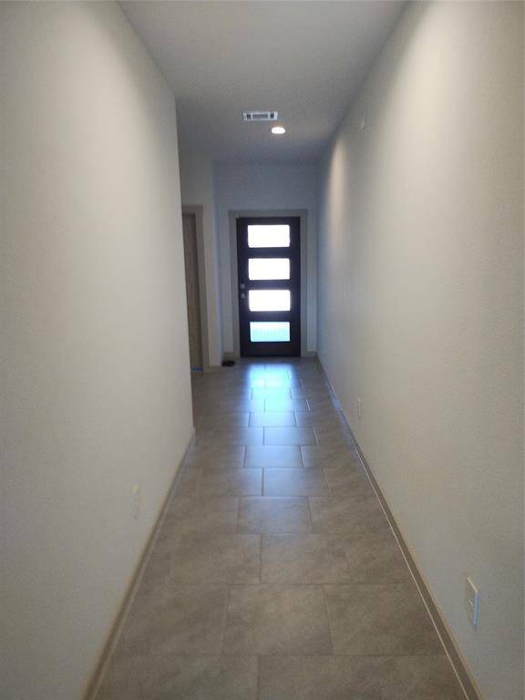 View of hallway looking towards beautiful front door.