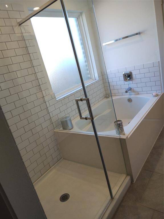 Primary bath with seamless shower and separate tub,