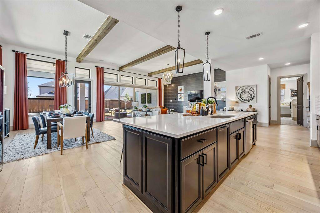 From the oversized island, take in views of the dining room, living space & backyard beyond—showcasing the open layout ideal for entertaining.