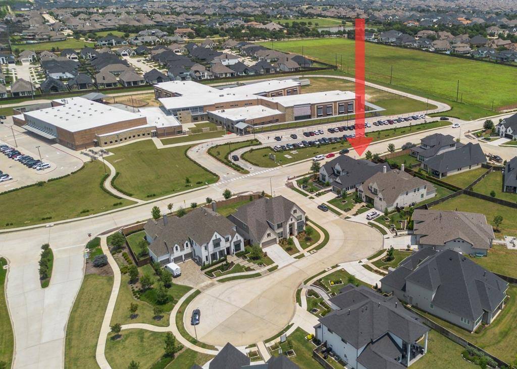 This aerial view highlights the home’s unbeatable location directly across from Robertson Elementary, offering unmatched convenience in a beautifully landscaped master-planned community.
