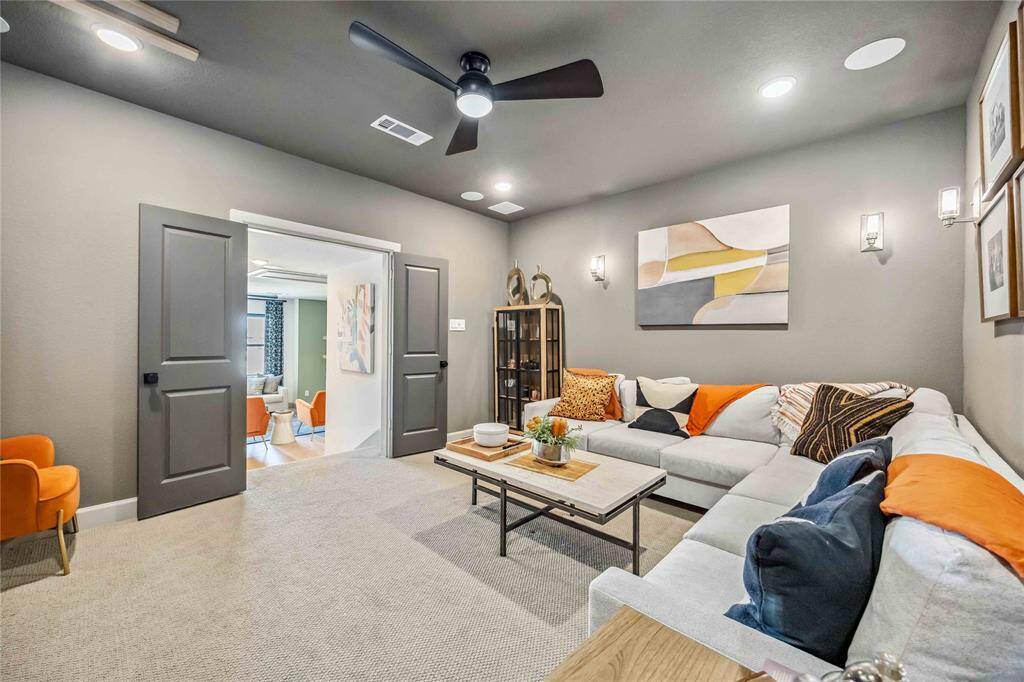 From movie marathons to game day gatherings, this inviting media room with French door entry offers the perfect space to unwind in style.