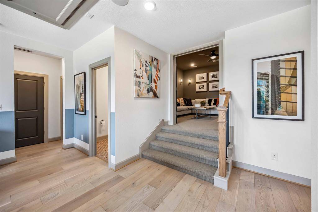 Perfect for entertaining, this upper landing offers direct access to the media room and a conveniently located half bath for guests.