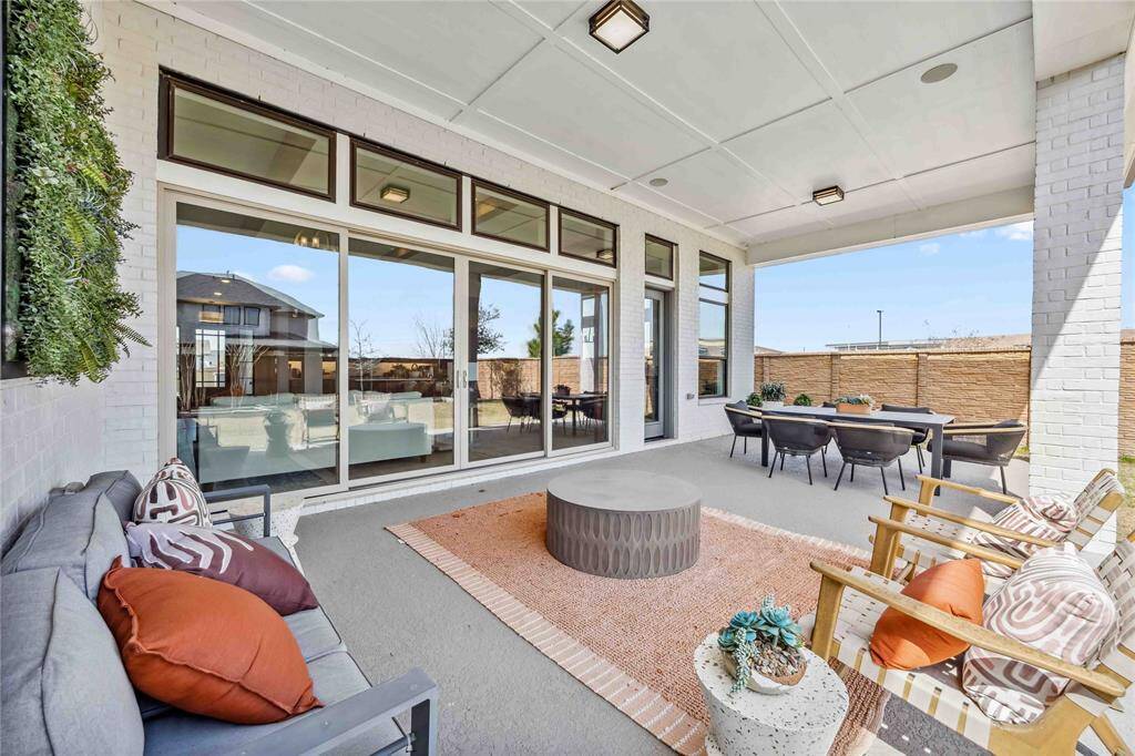 Spacious covered patio offers the perfect setting for outdoor lounging or entertaining, with seamless access to the main living area through expansive sliding glass doors.
