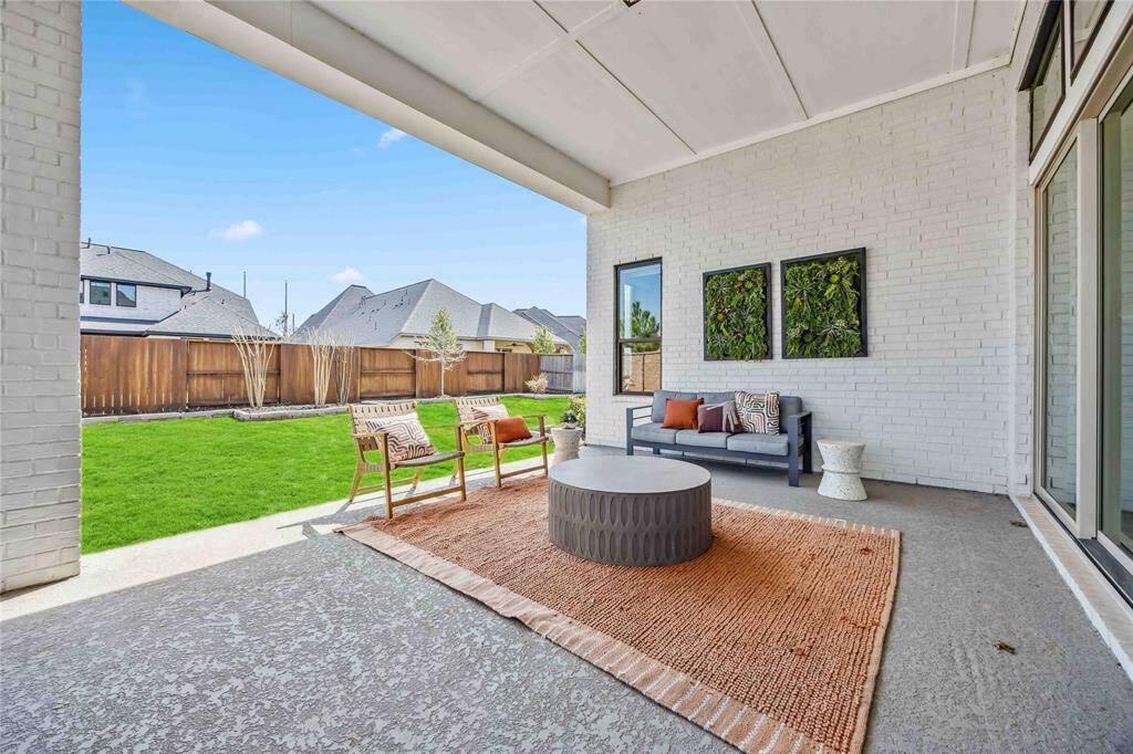 Enjoy outdoor living year-round with this large covered patio, complete with multiple seating areas and plenty of room to host guests.