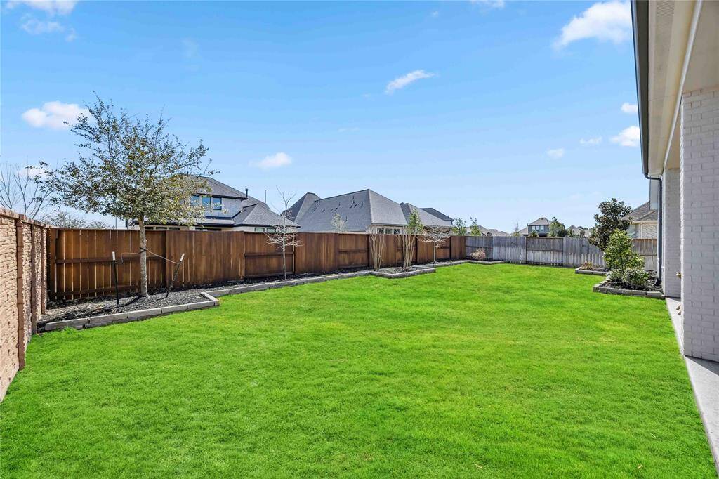 The oversized backyard provides plenty of space for recreation, a future pool, or custom landscaping to create your dream outdoor oasis.
