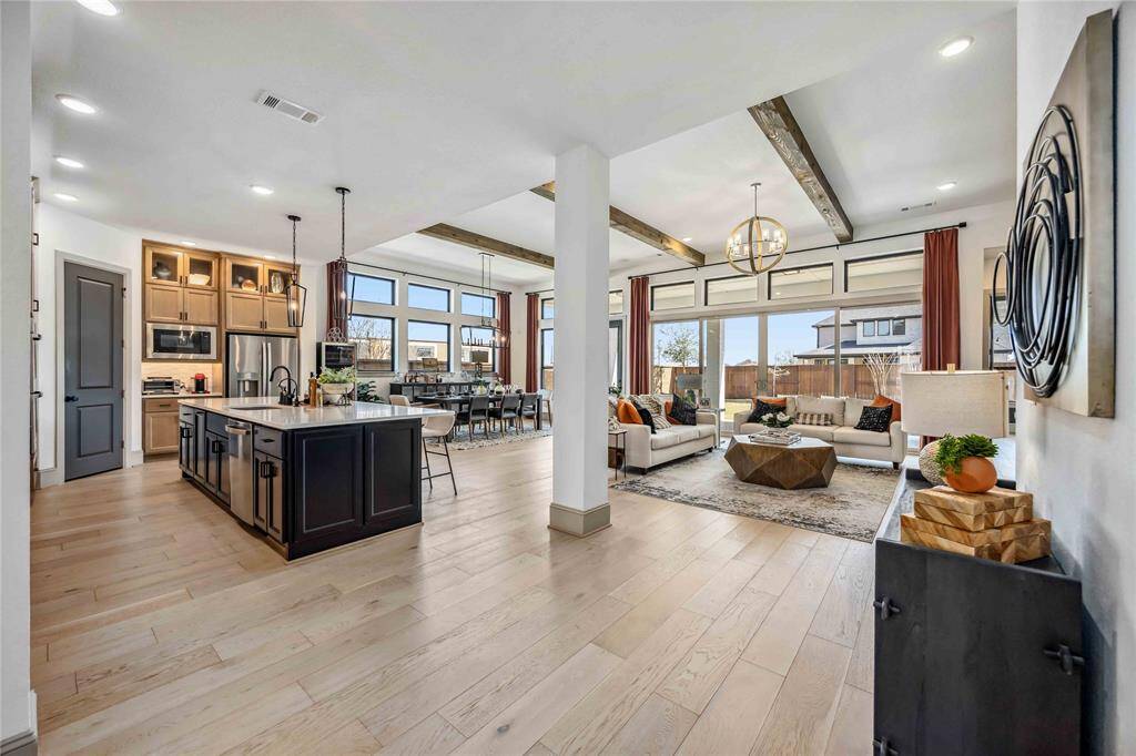This open-concept layout seamlessly connects the gourmet kitchen, spacious dining area, and sunlit living room—perfect for everyday living & entertaining alike.