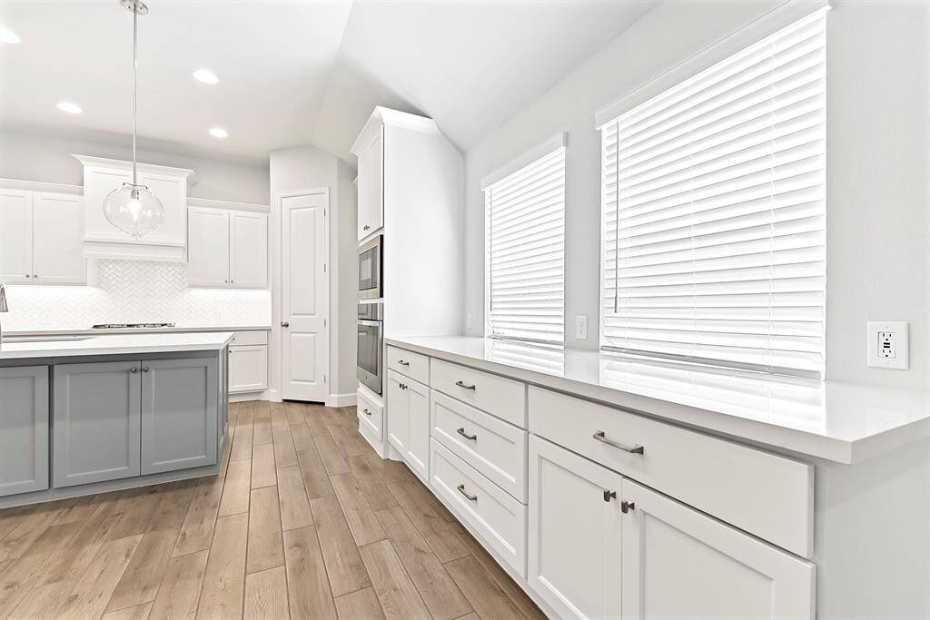 A closer look reveals additional storage and counter space in the built-in buffet area, complete with cabinetry, drawers, and a window that brings in natural light. This versatile space is perfect for hosting and serving, or it can easily be transformed into a coffee or wine bar.