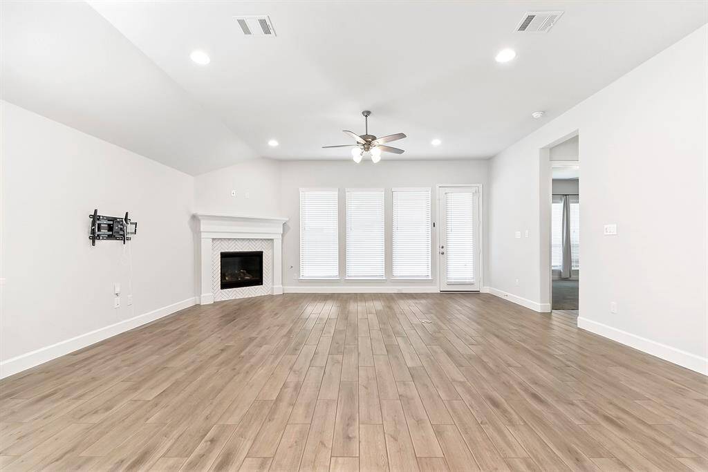Tucked in the back corner of the home is the spacious primary suite, offering comfort and privacy.