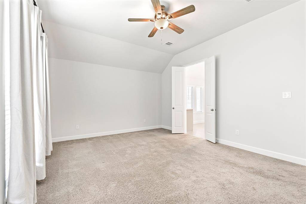 Another view showcases the generous space, easily accommodating all your large bedroom furniture with room to spare.