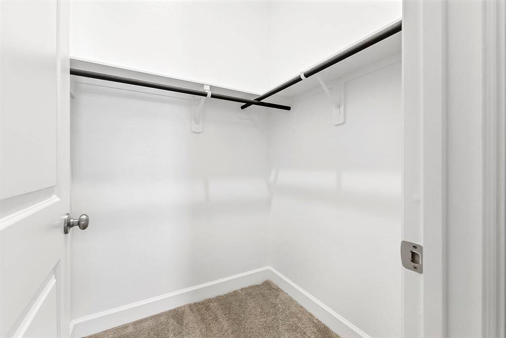 A generously sized walk-in closet makes this guest room feel even more spacious and functional.