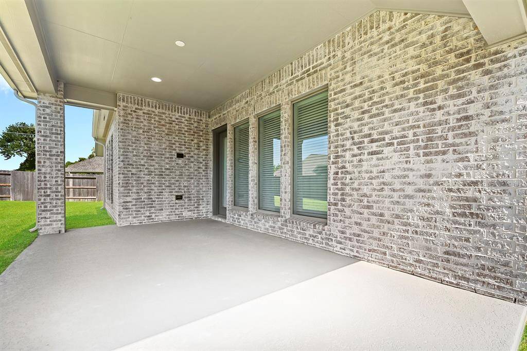 The large, oversized extended covered patio offers ample space for outdoor living and entertaining.