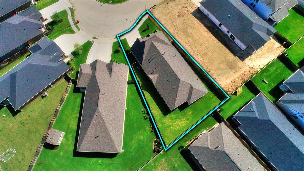 Aerial View of the Backyard the spacious backyard is highlighted, complete with an extended patio area, perfect for outdoor entertaining. You can see the well-maintained lawn and great from a play set of back yard activeisoffering a peaceful retreat right outside the door.
