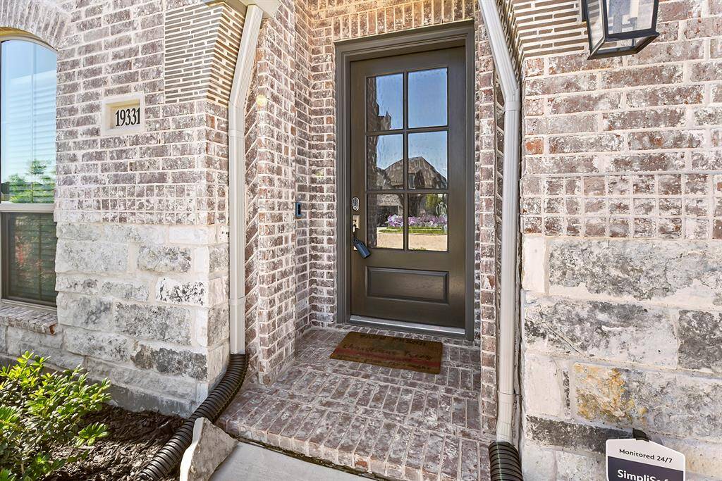 A covered entryway leads to the front door, which features a video doorbell (included) and keyless entry for added security and convenience.