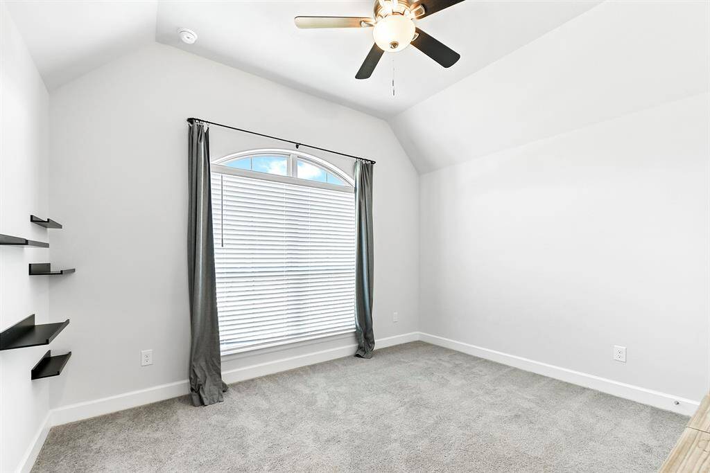 One of the front bedrooms offers a lovely view of the front yard and would make an ideal home office. All bedrooms feature plush carpeting, high ceilings with drop-down ceiling fans, and generous closet space—including walk-in closets. This is a must-see home!