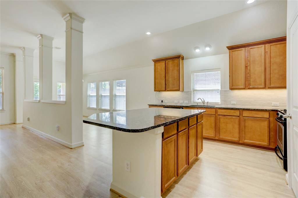 Island kitchen provides breakfast bar for bowls of cereal, homework, and casual conversations.