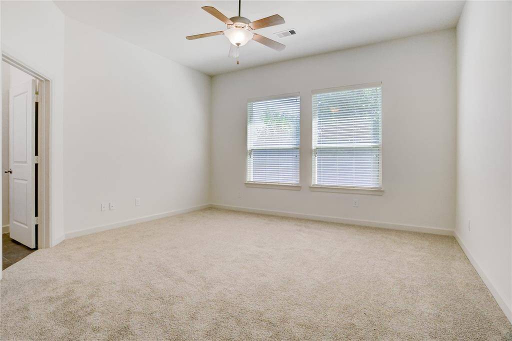 Primary bedroom is tucked away in the back with brand new carpet and views of the backyard.