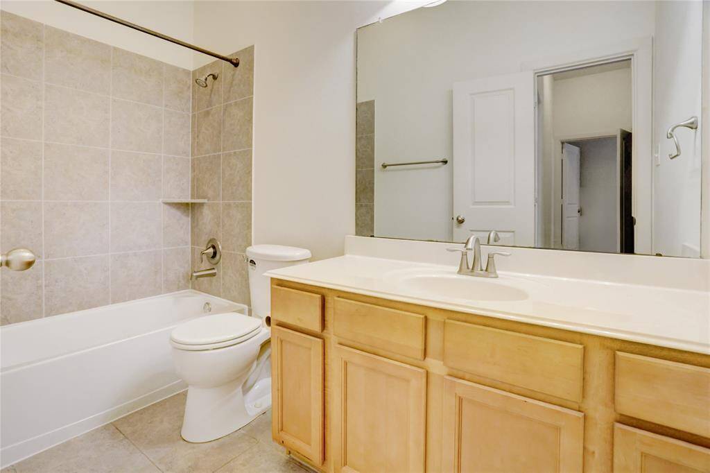 Secondary bathroom offers plenty of storage and a tub/shower combination.