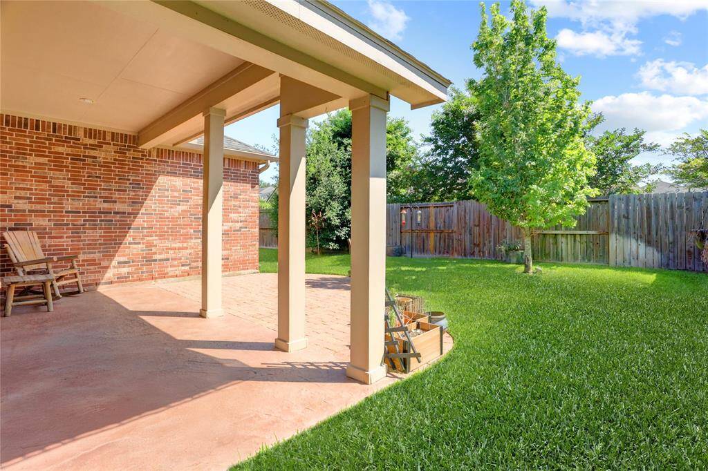 Backyard covered patio offers a space to relax and enjoy nature.