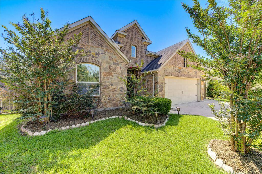 Beautifully maintained landscaping surrounds the home, creating a welcoming and polished curb appeal. Lush greenery, mature trees, and thoughtfully placed plants provide a serene outdoor setting that's both functional and visually appealing