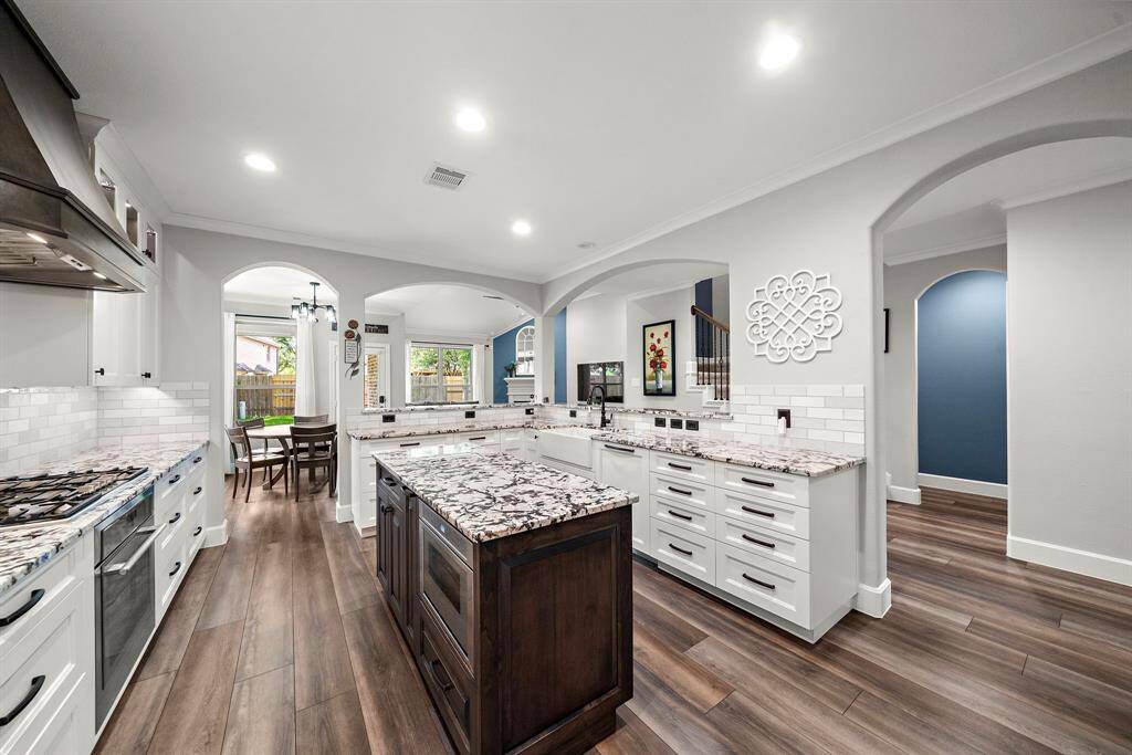 Recessed lighting and thoughtful layout create a light, open, and welcoming vibe that flows seamlessly into the adjacent breakfast room.
