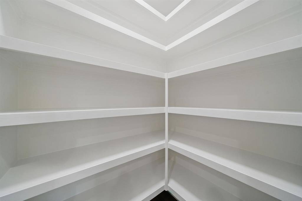 Custom pantry with heavy-duty shelving and bonus storage space and added shelving.